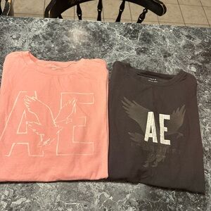 Two American Eagle T-shirts..  one price… One dark gray., one pink both large ￼